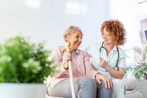 Older adult and family member reviewing daily care notes at a kitchen table