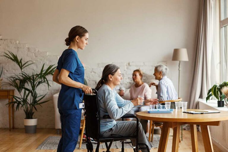Older adult and family member reviewing care options at a table with notes and a walker nearby